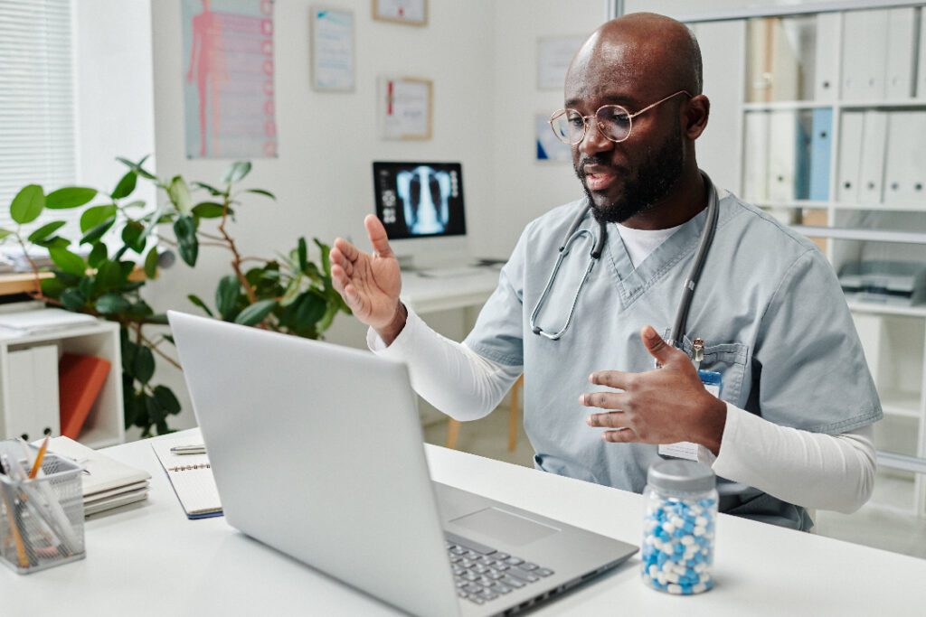 Doctor conducting a video consultation with X-ray images and medical tools